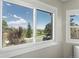Window view of landscape with trees, mountains and rooftops on a bright, sunny day at 15207 W Ellsworth Pl, Golden, CO 80401