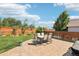Private backyard featuring patio with table and chairs, lovely lawn, and wood fence at 15948 E 106Th Pl, Commerce City, CO 80022