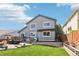 Backyard featuring a deck, a patio, a grill, and a luscious green lawn at 15948 E 106Th Pl, Commerce City, CO 80022