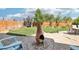 Backyard with a clay chiminea on a patio and lush green grass at 15948 E 106Th Pl, Commerce City, CO 80022