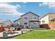 Backyard featuring a deck, a patio, a grill, and a luscious green lawn at 15948 E 106Th Pl, Commerce City, CO 80022