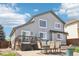 Inviting backyard patio with seating and dining, complemented by a well-maintained gray home for comfortable outdoor living at 15948 E 106Th Pl, Commerce City, CO 80022
