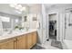 Bright bathroom with double sinks, a shower, and a separate toilet room at 15948 E 106Th Pl, Commerce City, CO 80022