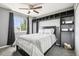 Charming bedroom featuring a modern ceiling fan, stylish shelving and a comfy bed at 15948 E 106Th Pl, Commerce City, CO 80022