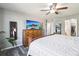 Relaxing bedroom with a ceiling fan and a large dresser that has a TV on top of it at 15948 E 106Th Pl, Commerce City, CO 80022
