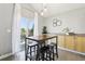 Cozy breakfast nook with natural light, a wooden table with stools, and cabinetry for storage at 15948 E 106Th Pl, Commerce City, CO 80022