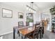Open dining room with a table that seats six, hardwood floors, and modern light fixture at 15948 E 106Th Pl, Commerce City, CO 80022