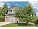Well maintained two-story home with mature trees, manicured yard, and a two-car garage at 15948 E 106Th Pl, Commerce City, CO 80022