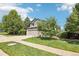 This two-story home features a well manicured front yard and a two car garage at 15948 E 106Th Pl, Commerce City, CO 80022