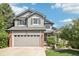 Charming exterior view of a well-maintained two-story home with a two-car garage and beautiful landscaping at 15948 E 106Th Pl, Commerce City, CO 80022