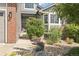 This home features a front entryway with a small porch and lots of flower pots at 15948 E 106Th Pl, Commerce City, CO 80022