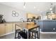 Eat-in kitchen features a dining room table with bar stool seating and hardwood floors at 15948 E 106Th Pl, Commerce City, CO 80022