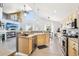 Kitchen features a sink overlooking the living room and stainless steel appliances at 15948 E 106Th Pl, Commerce City, CO 80022