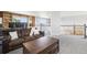 Upstairs living area featuring built-in bookshelves, and plush furniture at 15948 E 106Th Pl, Commerce City, CO 80022