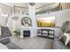 Inviting living room featuring a fireplace, a comfortable sofa, and an entertainment center for cozy evenings at 15948 E 106Th Pl, Commerce City, CO 80022