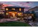 Backyard with patio and hot tub, illuminated by string lights at dusk at 21502 E Idyllwilde Dr, Parker, CO 80138