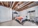 Unfinished basement features exposed ceiling, a window, and an installed bedroom at 21502 E Idyllwilde Dr, Parker, CO 80138
