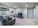 Relaxing finished basement with modern furnishings, including a leather sofa and television at 21502 E Idyllwilde Dr, Parker, CO 80138
