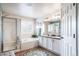 Bright bathroom with a glass enclosed shower, soaking tub, and dual sink vanity at 21502 E Idyllwilde Dr, Parker, CO 80138