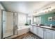 Bright bathroom with a glass enclosed shower, soaking tub, and dual sink vanity at 21502 E Idyllwilde Dr, Parker, CO 80138