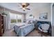 Bright bedroom featuring a ceiling fan and a large window offering a pleasant outdoor view at 21502 E Idyllwilde Dr, Parker, CO 80138