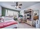 Inviting bedroom with a ceiling fan, large window, and display cabinet at 21502 E Idyllwilde Dr, Parker, CO 80138