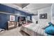 Cozy bedroom with textured blue wall, TV, and stylish decor and furnishings at 21502 E Idyllwilde Dr, Parker, CO 80138