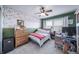 Comfortable bedroom with leafy accent wall, ceiling fan, and cozy decor at 21502 E Idyllwilde Dr, Parker, CO 80138