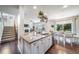Modern kitchen with a large center island, hardwood floors, and open to the dining and living areas at 21502 E Idyllwilde Dr, Parker, CO 80138