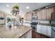 Bright kitchen featuring granite countertops, stainless steel appliances, and wood cabinets at 21502 E Idyllwilde Dr, Parker, CO 80138