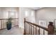 Second floor landing featuring a wood railing and plant with views of windows and art at 21502 E Idyllwilde Dr, Parker, CO 80138