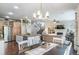 Open-concept living area, seamlessly connecting the kitchen, dining room, and living room with fireplace at 21502 E Idyllwilde Dr, Parker, CO 80138