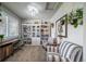 Bright office space featuring built-in bookshelves, a desk, and comfortable seating area at 21502 E Idyllwilde Dr, Parker, CO 80138