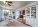 Bright office space featuring a ceiling fan, large window, and storage cabinets at 21502 E Idyllwilde Dr, Parker, CO 80138