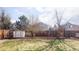 Large backyard with a shed, playset, mature trees and a wooden fence at 4128 S Riviera St, Aurora, CO 80018