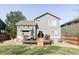 View of the backyard with a deck, patio furniture, and a well-maintained lawn at 4128 S Riviera St, Aurora, CO 80018