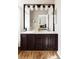 Bathroom features a double sink vanity with dark wood cabinets, light countertops, and a view into the bedroom at 4128 S Riviera St, Aurora, CO 80018