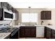 Well-lit kitchen featuring modern appliances and generous countertop space at 4128 S Riviera St, Aurora, CO 80018