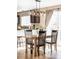 Charming kitchen and dining area with modern light fixtures and sliding glass doors at 4128 S Riviera St, Aurora, CO 80018