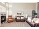 Spacious living area featuring a cozy fireplace and comfortable seating at 4128 S Riviera St, Aurora, CO 80018