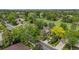 Aerial view of home and property surrounded by mature trees, and a golf course in the distance at 78 Fairway Ln, Littleton, CO 80123