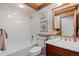 Clean and bright bathroom featuring a tub, wooden vanity, and stylish decor at 78 Fairway Ln, Littleton, CO 80123