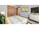 Cozy bedroom with neutral tones, decorative pillows, and ample closet space at 78 Fairway Ln, Littleton, CO 80123