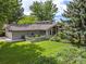 Charming single-story home with lush front yard and beautiful landscaping and attached garage at 78 Fairway Ln, Littleton, CO 80123