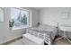 Comfortable bedroom with bright natural light and a view of mature trees outside the window at 1885 S Quebec Way # D22, Denver, CO 80231