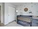 Bedroom showcasing a crib, closet, and decor on the wall at 1885 S Quebec Way # D22, Denver, CO 80231