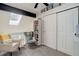 Bedroom with comfortable seating, a bookshelf and storage under a slanted ceiling with skylight at 1885 S Quebec Way # D22, Denver, CO 80231