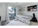 Cozy bedroom with access to a balcony, decorative shelves, and neutral tones at 1885 S Quebec Way # D22, Denver, CO 80231
