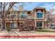 Charming condo building with two stories, wood deck and siding, and well-maintained landscaping at 1885 S Quebec Way # D22, Denver, CO 80231