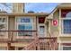 Exterior of the townhome showing a unit entrance and a wooden deck area at 1885 S Quebec Way # D22, Denver, CO 80231